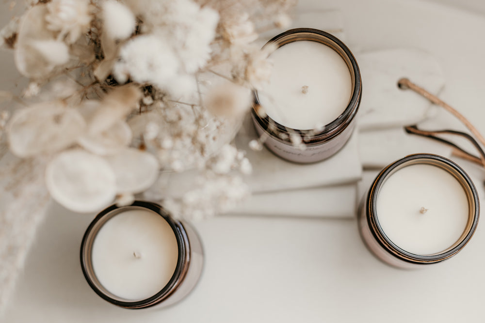 Soy wax candles in amber glass jars.