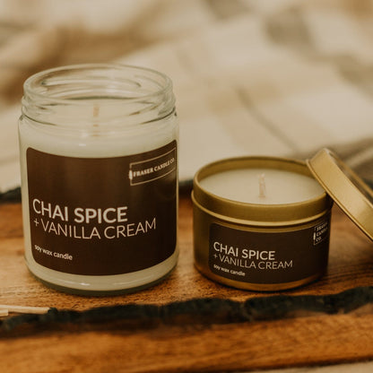soy wax candle with chai spice and vanilla cream scent notes in a 9 oz glass jar and a 4 oz gold tin
